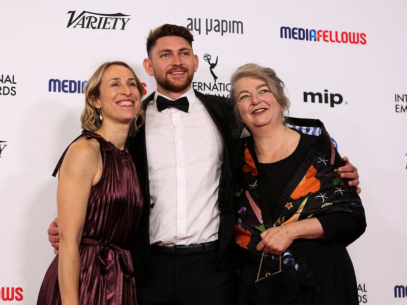 Blayke Hoffman, Jo-Anne McGowan and Harley Windsor, pose with the award for Best Sports Documentary for 