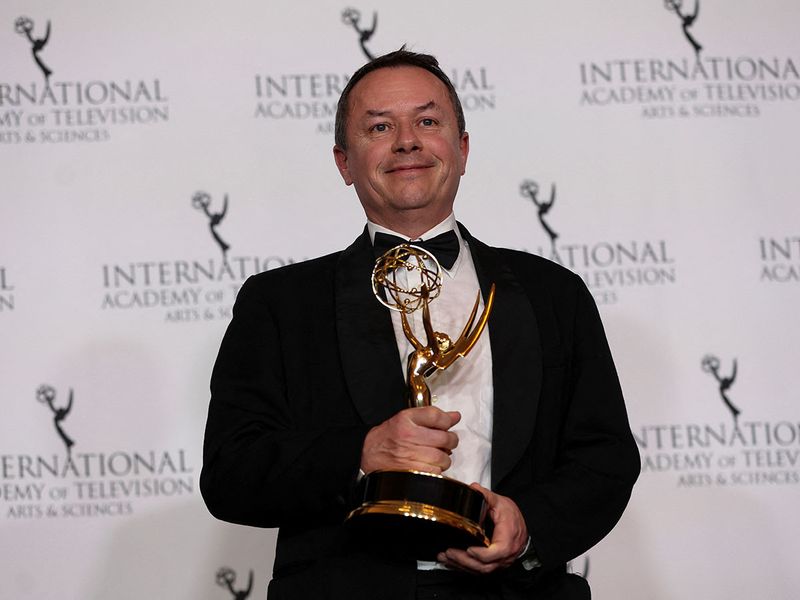 Executive Producer Darren Kemp poses with the Best Documentary award for 