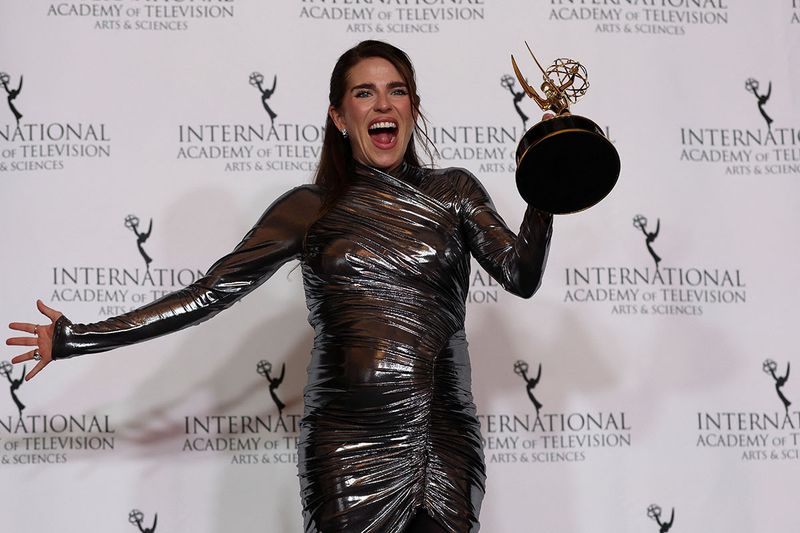 Karla Souza  poses with the Best Performance by an Actress award for 