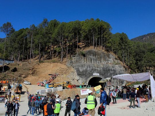 Media personnel and onlookers gather near the entrance of a tunnel under construction where workers are trapped following a collapse, in Uttarkashi, in the northern state of Uttarakhand, India, November 24, 2023. 