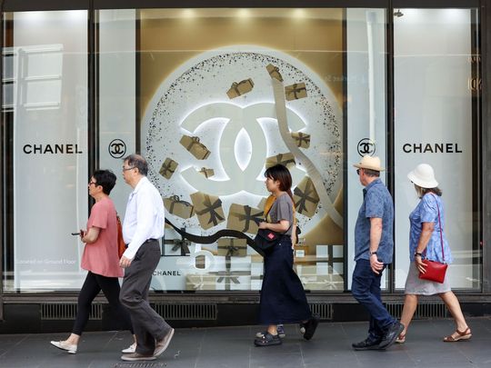 Pedestrians walks past a Chanel SA window display at a David Jones store in Sydney, Australia, on Wednesday, Nov. 22, 2023