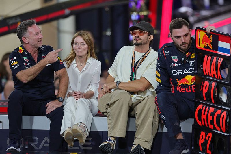 ed Bull Racing's British team principal Christian Horner (L) sits with his wife British singer Geri Halliwell and British actor Orlando Bloom as they celebrate after the Abu Dhabi Formula One Grand Prix at the Yas Marina Circuit in the Emirati city on November 26, 2023. (Photo by Giuseppe CACACE / AFP)