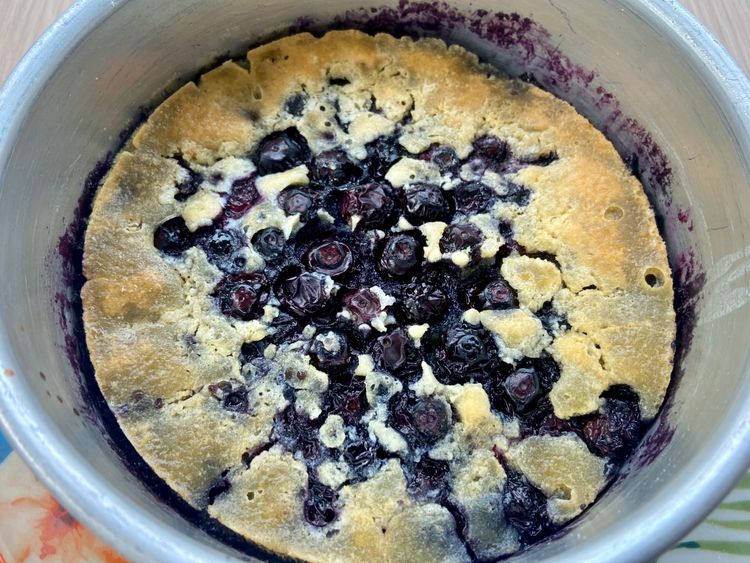 The blueberries sink to the bottom as they bake, and the batter rises at the top, forming a golden crust