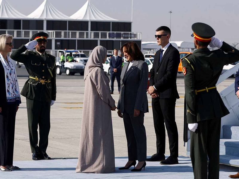 US Ambassador to the United Arab Emirates Martina Strong and Minister of State for Advanced Technology of the United Arab Emirates Sarah bint Yousef Al Amiri welcome US Vice President Kamala Harris as she arrives to attend the United Nations Climate Change Conference (COP28) in Dubai.