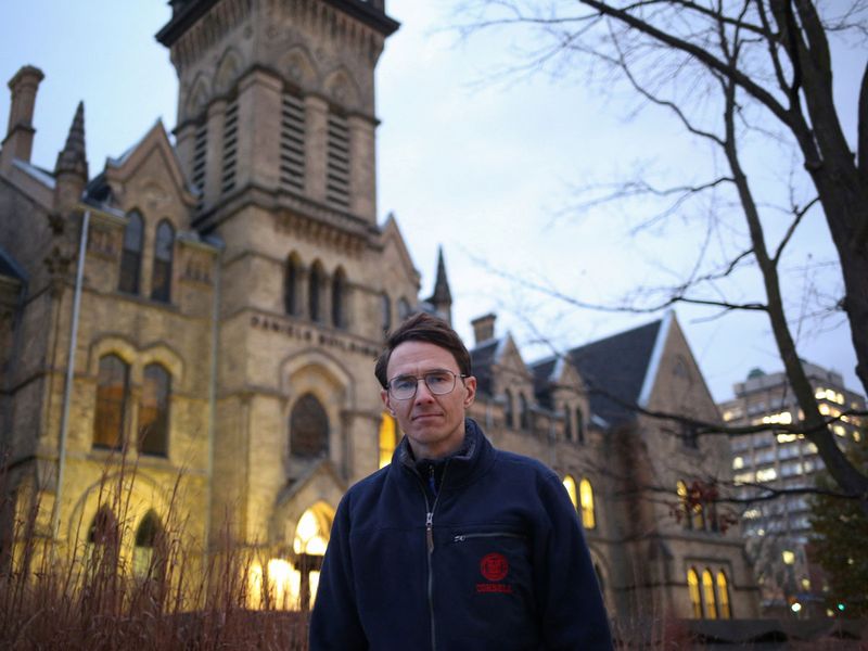 Justinas Stankus, 38, who came to Canada from Lithuania in 2019 and is studying at the University of Toronto, poses on the campus in Toronto, Ontario, Canada, November 29, 2023