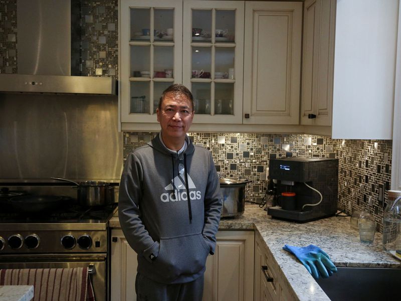 Myo Maung, 55, who immigrated from Myanmar to Canada over three decades ago, poses for photos at his home in Toronto, Ontario, Canada, December 6, 2023