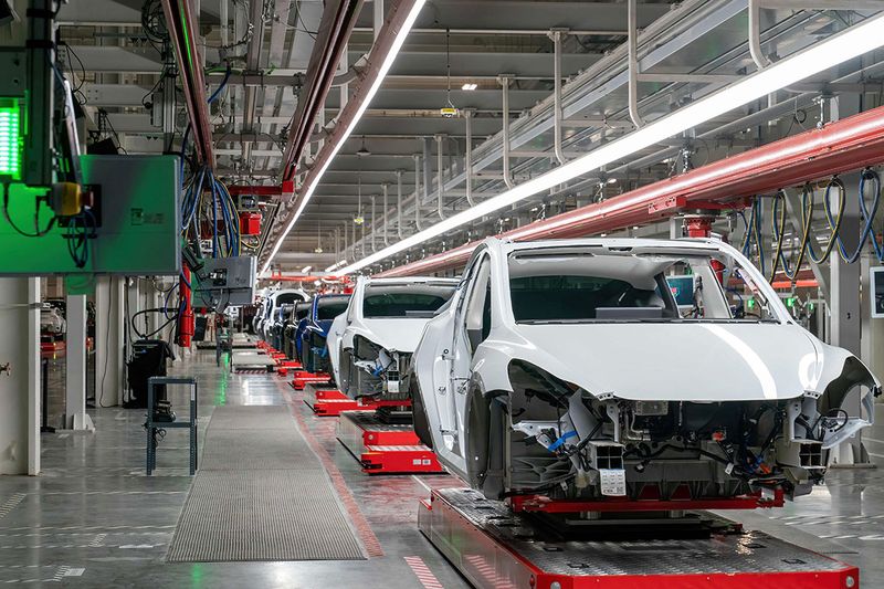 (FILES) Cars are seen on the assembly line during a tour of the Tesla Giga Texas manufacturing facility ahead of the 