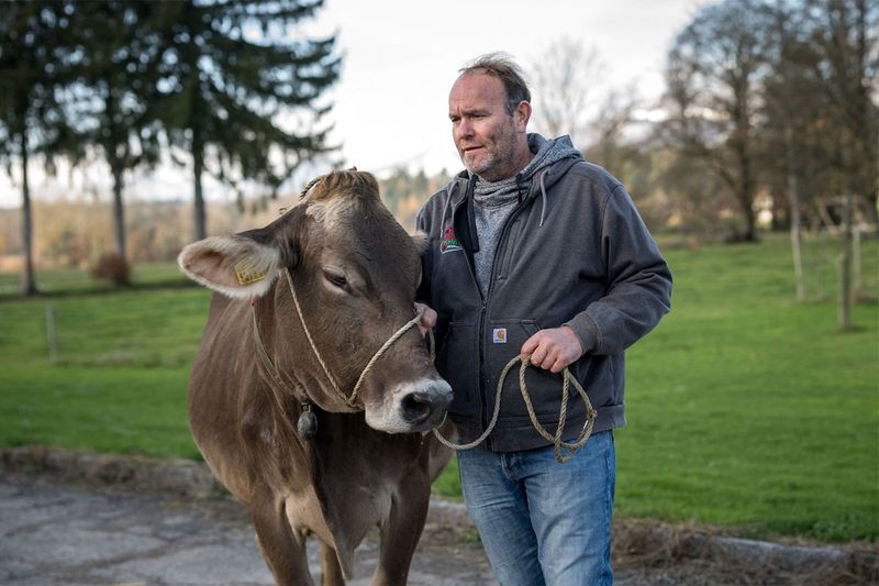 Farmer Rolf Rohrbach (L) poses with cow 
