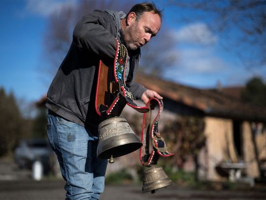 Farmer Rolf Rohrbach (L) poses with cow bells used during transhumance in the village of Aarwangen, central Switzerland, on November 29, 2023.  Photograph:(AFP)