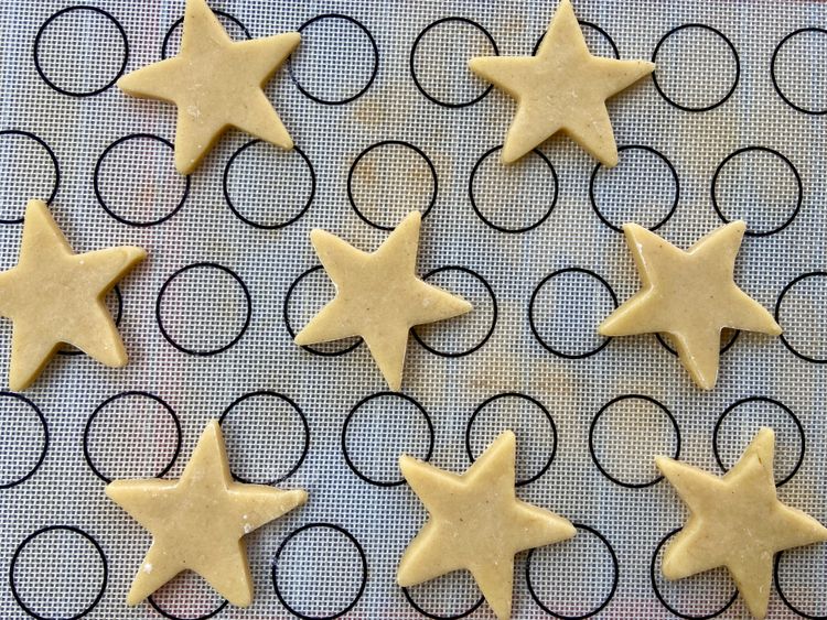 Cut out 10 star-shaped cookies and place them 2 inches apart on a lined baking tray.