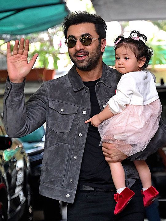 Bollywood actor Ranbir Kapoor poses with his daughter Raha upon their arrival for a Christmas brunch in Mumbai on December 25, 2023. (Photo by Sujit JAISWAL / AFP)