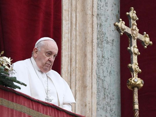 Pope Francis stands at the balcony of St. Peter's basilica to delivers the Christmas Urbi et Orbi blessing in St. Peter's Square at The Vatican on December 25, 2023. 