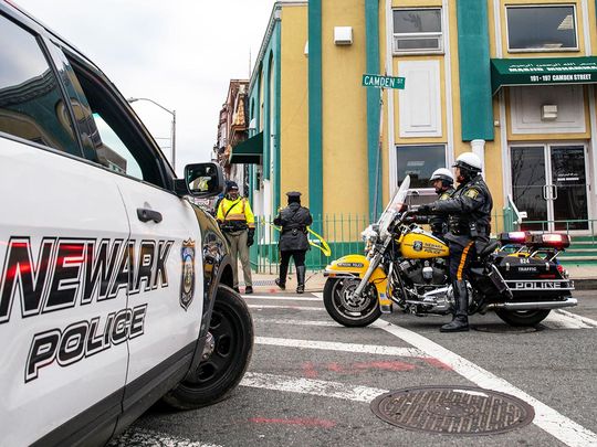 Newark Police Officers stand guard outside the Masjid Muhammad-Newark mosque following the shooting of Imam Hassan Sharif in Newark, New Jersey, on January 3, 2024. 