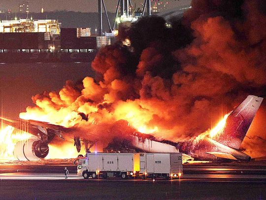 This photo provided by Jiji Press shows a Japan Airlines plane on fire on a runway of Tokyo's Haneda Airport on January 2, 2024.  