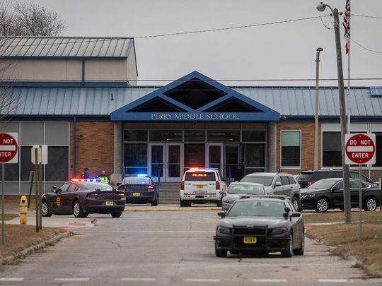 Police officers secure the campus at Perry Middle and High School during a shooting situation in Perry, Iowa, on January 4, 2024. 