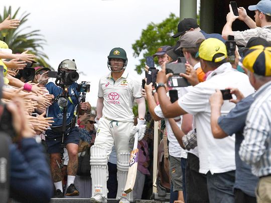 Fans cheer on Australia’s David Warner as he walks out to bat f