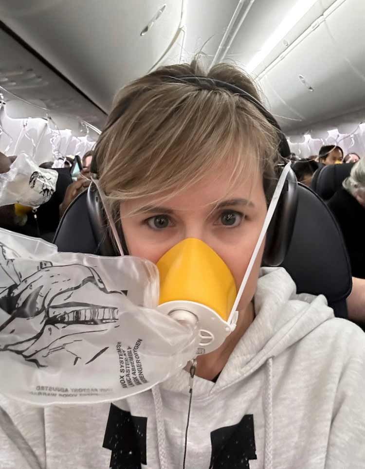 This image provided by Kelly Bartlett shows Bartlett wearing an oxygen mask on an Alaska Airlines Boeing 737 Max 9, Flight 1282, which was forced to return to Portland International Airport after the jetliner blew out a portion of its fuselage on Friday, Jan. 5, 2024.