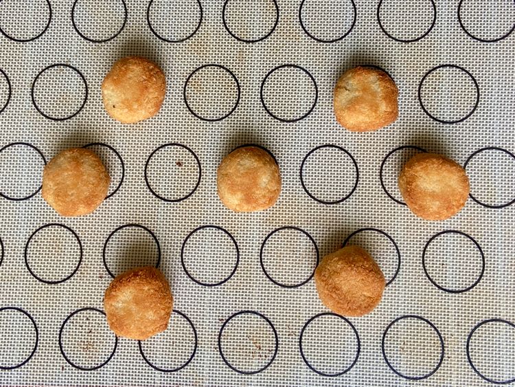 Shape dough into 1.5-inch balls. Place on lined tray with 2-inch gap. Bake 20-25 min until golden brown.