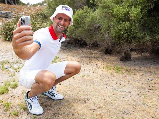 A handout photo taken on December 29, 2023 and released on December 30 by Tennis Australia shows Serbia's Novak Djokovic taking a selfie with quokka on Rottnest Island