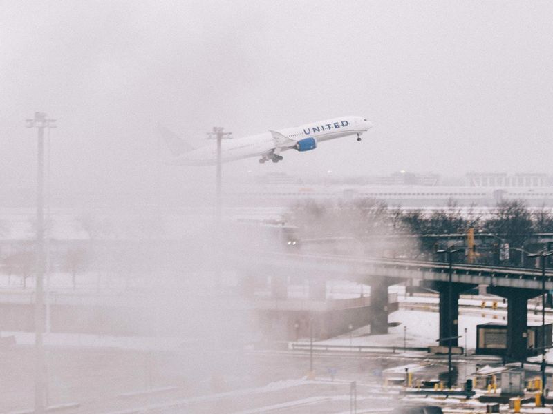 An airplane takes off during blizzard conditions at O'Hare Airport in Chicago, Illinois. 