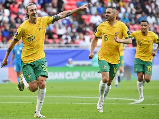 Australia's midfielder Jackson Irvine (left) celebrates 