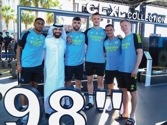 Arsenal players, Reiss Nelson, David Raya Martín, Karl Jakob Hein, Cédric Soares, and Oleksandr Zinchenko (from L to R), with Khalid Al Ameri (2nd from L) at the TCL Experience Zone on JBR Beach in Dubai, during the meet-and-greet event.