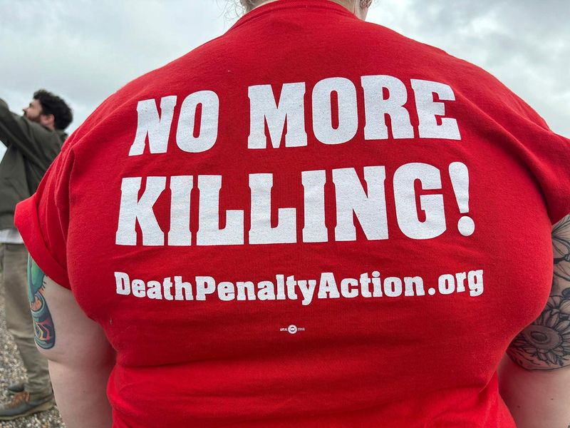 Anti-death penalty activists place signs 
