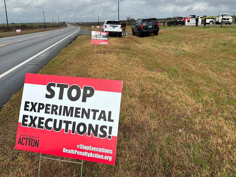Anti-death penalty activists place signs along the road heading to Holman Correctional Facility in Atmore, Alabama, ahead of the scheduled execution of Kenneth Eugene Smith on January 25, 2024. 
