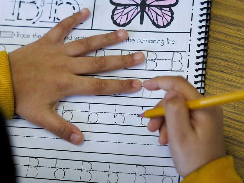 A student at Luther Burbank Elementary School practices making letters as California grade school students will be required to learn cursive handwriting, in Artesia, California, U.S. January 23, 2024. 