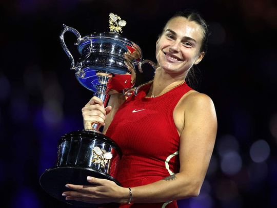 Belarus' Aryna Sabalenka celebrates with the Daphne Akhurst Memorial Cup after defeating China's Zheng Qinwen during their women's singles final match on day 14 of the Australian Open tennis tournament in Melbourne on January 27, 2024.