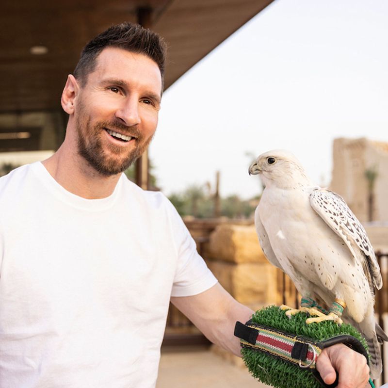 Messi holds a white falcon in Saudi Arabia