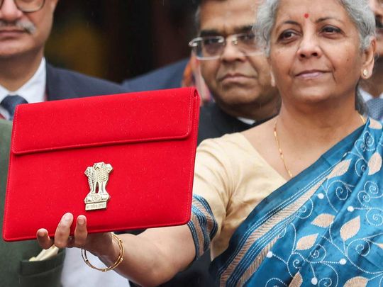 India's Finance Minister Nirmala Sitharaman holds up a folder with the Government of India's logo as she leaves her office to present the federal budget in the parliament, ahead of the nation's general election, in New Delhi, India, February 1, 2024.