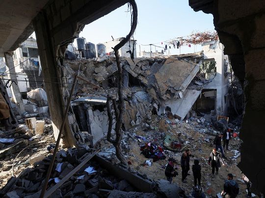 Palestinians inspect the site of an Israeli strike in Rafah in the southern Gaza Strip on February 3, 2024. 