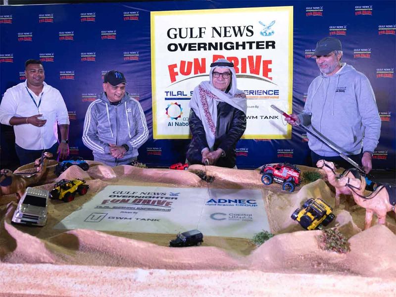 Abdul Hamid Ahmad, CEO & Editor In Chief of Gulf News, cuts the cake at the end of the Gulf News Fun Drive. Suraj Shetty, Muhammad Imran, and Marclino Fernandes, COO- Gulf News are also seen. 