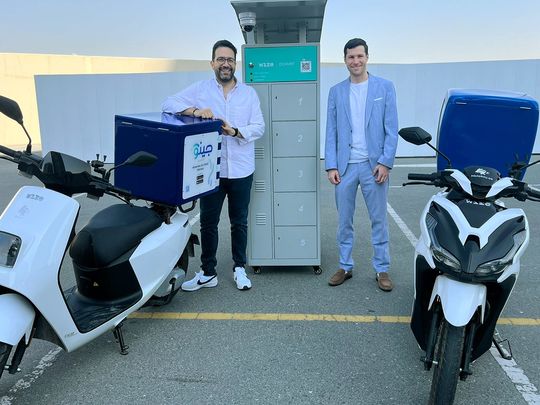 Bechara Haddad GM Jino Mobility & Alexander Lemzakov CEO Wize, next to the swappable battery station and EV Bikes
