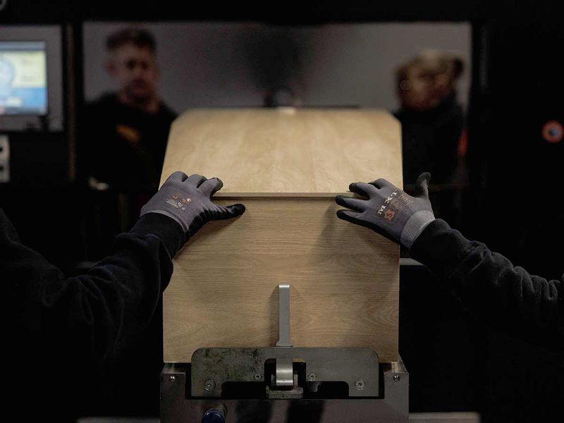 Lydie Imhoff's coffin is pushed in the crematory oven by two workers at the Daelhof Crematorium in Zemst, Belgium, on February 5, 2024.  