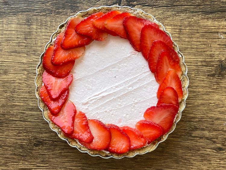 Take the sliced strawberries and arrange them in concentric circles, overlapping each other.