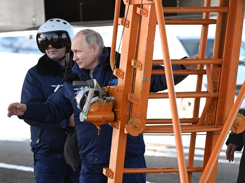 In this pool photograph distributed by Russian state agency Sputnik, Russia's President Vladimir Putin gets ready to fly in a Tupolev Tu-160M strategic bomber in Kazan on February 22, 2024.  