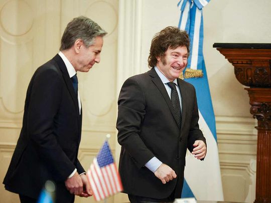 Argentina's President Javier Milei (right) walks with US Secretary of State Antony Blinken