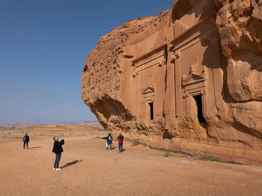 Tourists during a visit to the ancient archaeological site of Hegra in AlUla, Saudi Arabia. 