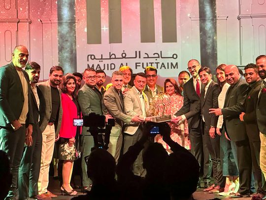 Team Homes 4 Life Real Estate receiving the award at the Tilal Al Ghaf Awards