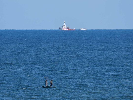 A ship belonging to the Open Arms aid group approaches the shores of Gaza towing a barge with 200 tons of humanitarian aid on Friday, March 15, 2024. 
