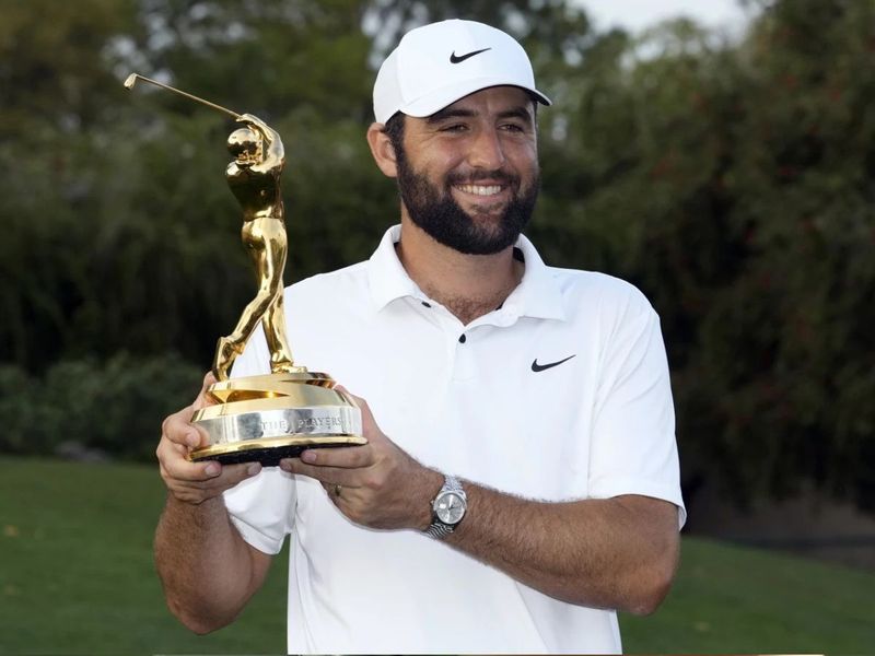 Scheffler poses with the Players Championship trophy