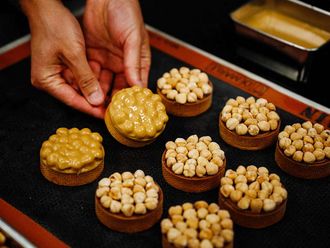 Pastry chef from Nice Philippe Tayac displays tartelettes with hazelnuts and 'blond' chocolate at Valrhona chocolatier in Paris. 