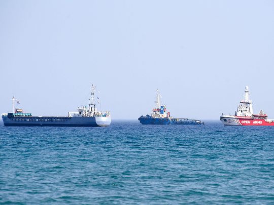 An Open Arms ship and another vessel sail towards the ship Jenifer, of the World Central Kitchen carrying food aid for the Gaza Strip, as they prepare to set sail close to the port of Larnaca in Cyprus on March 30, 2024.  