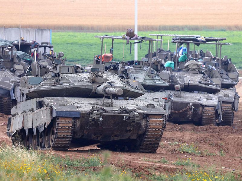 Israeli army tanks move in an area along the border with the Gaza Strip and southern Israel on April 10, 2024, amid the ongoing conflict in the Palestinian territory between Israel and the militant group Hamas. 
