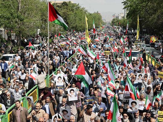 Iranian's wave the flags of Palestine and Iran 