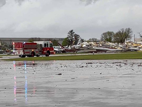 Emergency personnel work next to the damages caused by a tornado at Eppley Airfield, in Omaha, Nebraska, U.S. April 26, 2024, in this still image obtained from a social media video