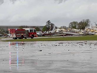 Emergency personnel work next to the damages caused by a tornado at Eppley Airfield, in Omaha, Nebraska, U.S. April 26, 2024, in this still image obtained from a social media video