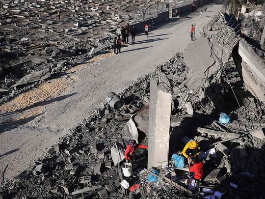 Palestinians salvage belongings from the rubble of a house hit by overnight Israeli bombing in Rafah in the southern Gaza Strip on April 20, 2024, amid the ongoing conflict between Israel and the Hamas movement. 